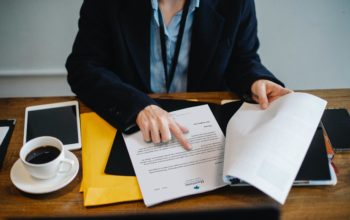 Siedzący przy stole mężczyzna analizuje dane z dokumentu